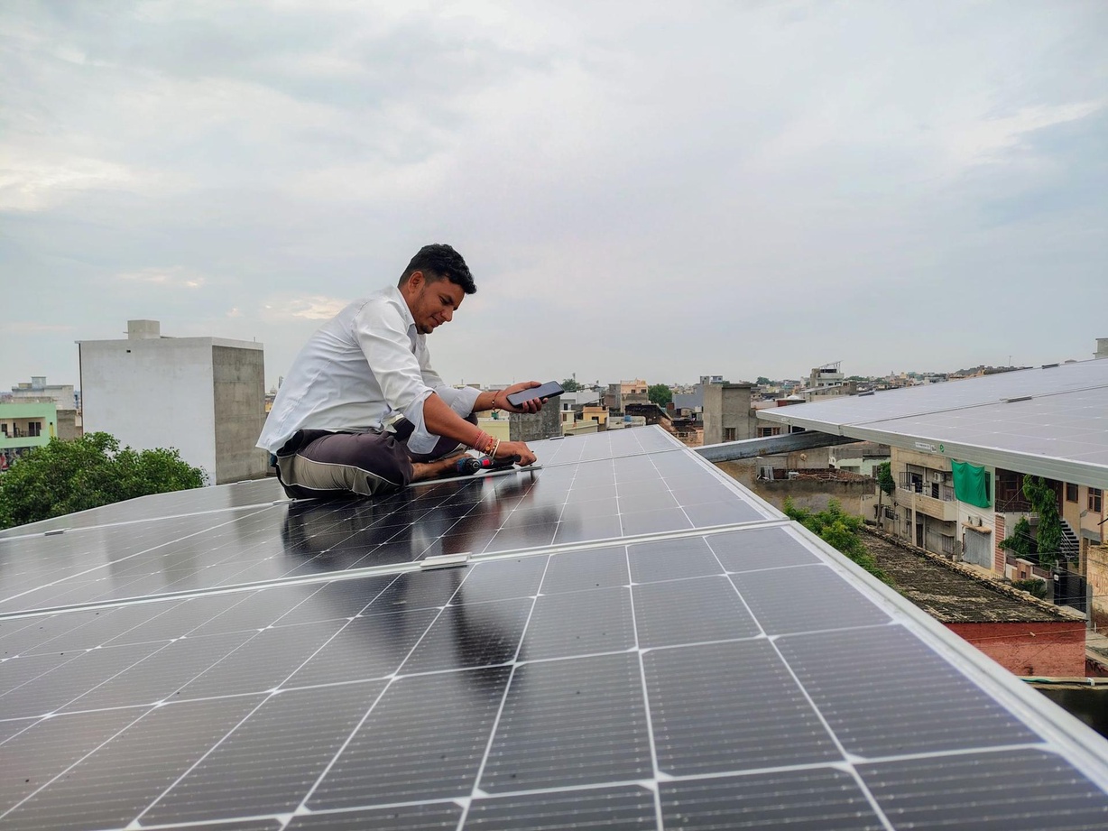 Man sitting on a solar panel