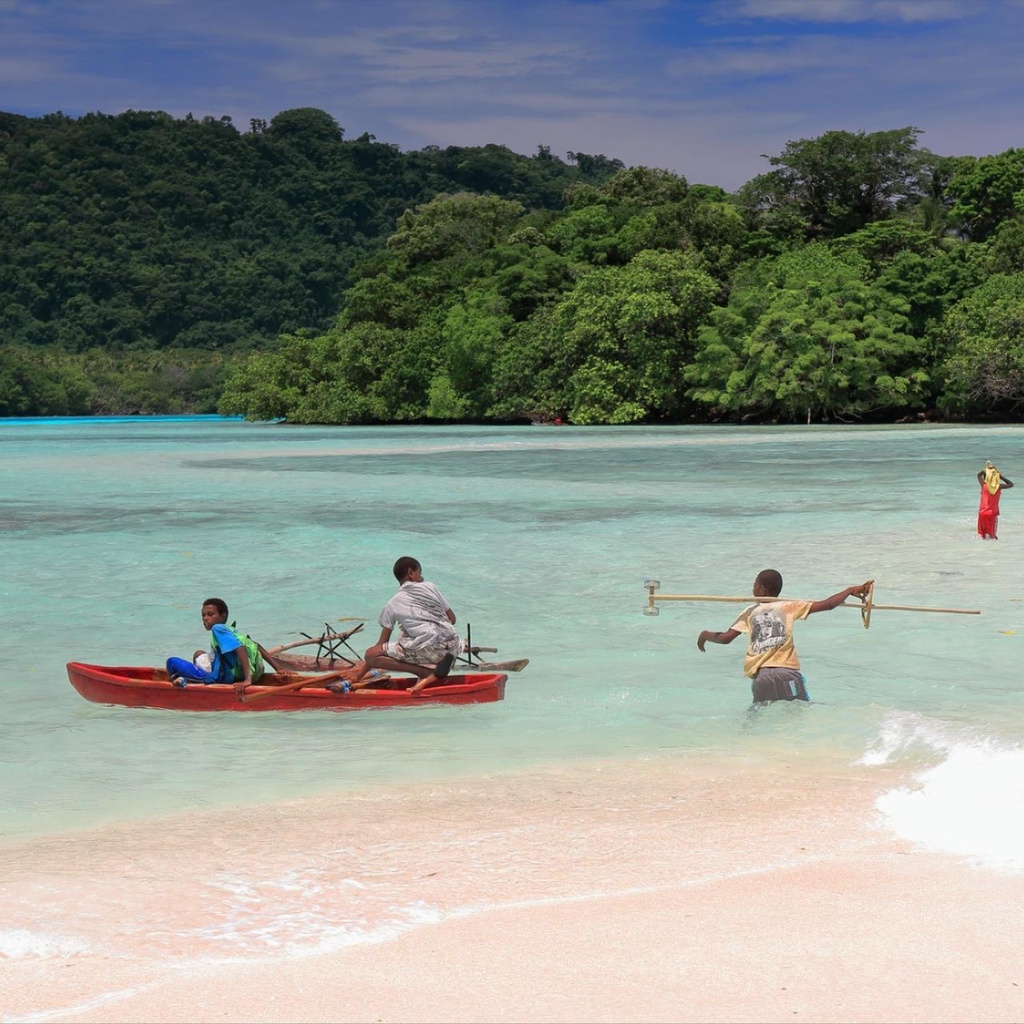 A boat floating by the beach