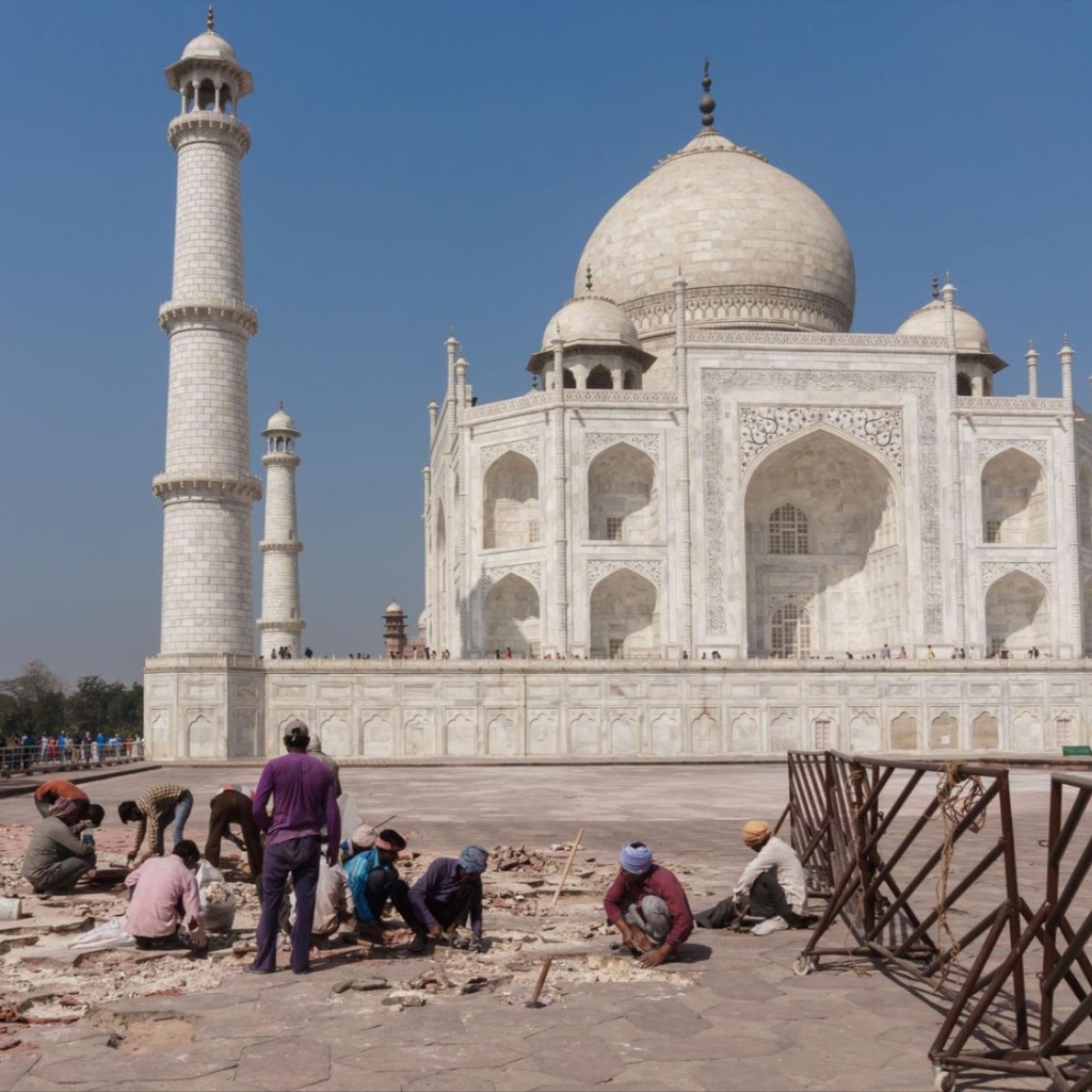 A man pushes a boat to shore in Bali, Indonesia